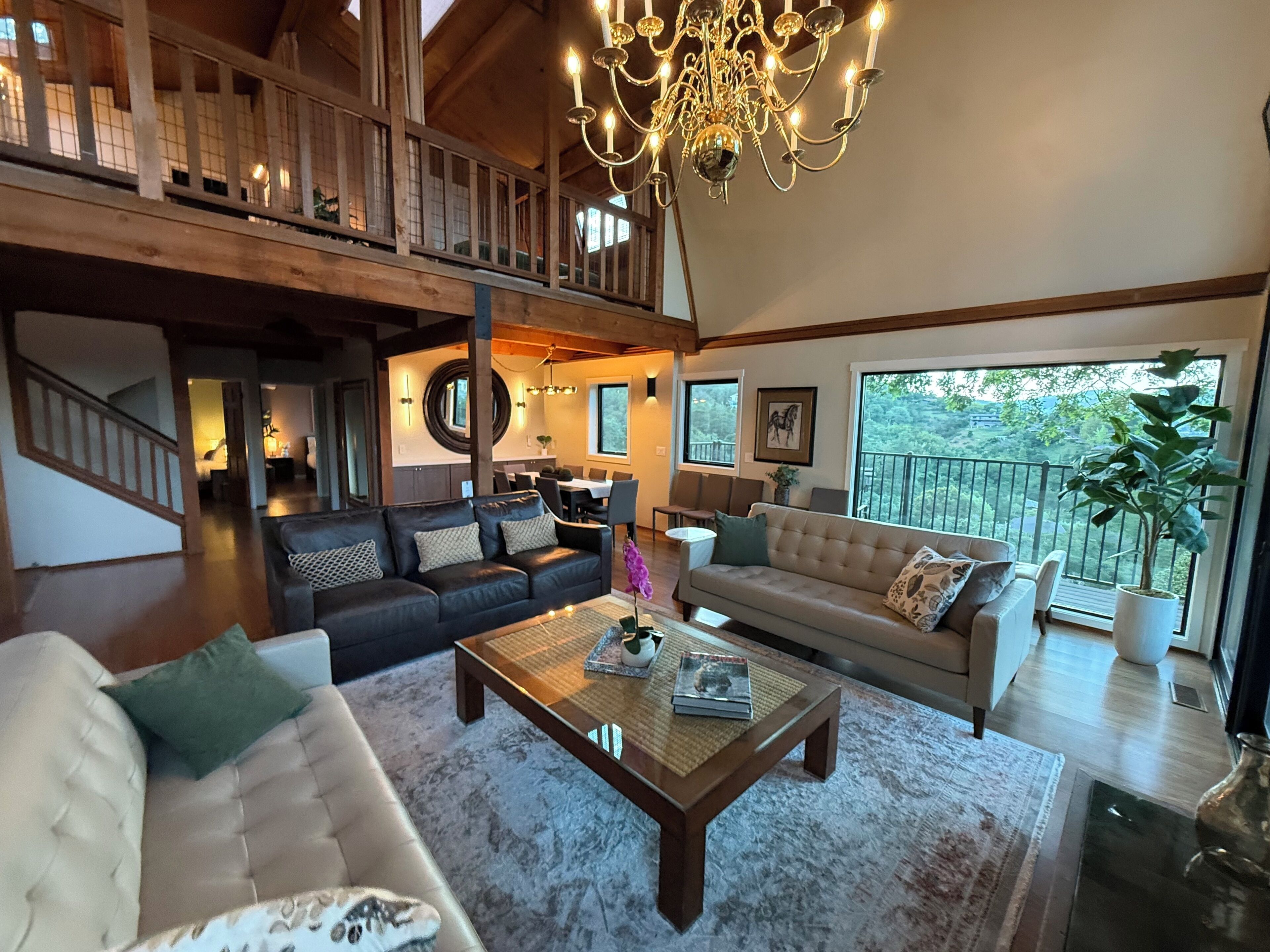 Great room with a high ceiling, chandelier and fireplace