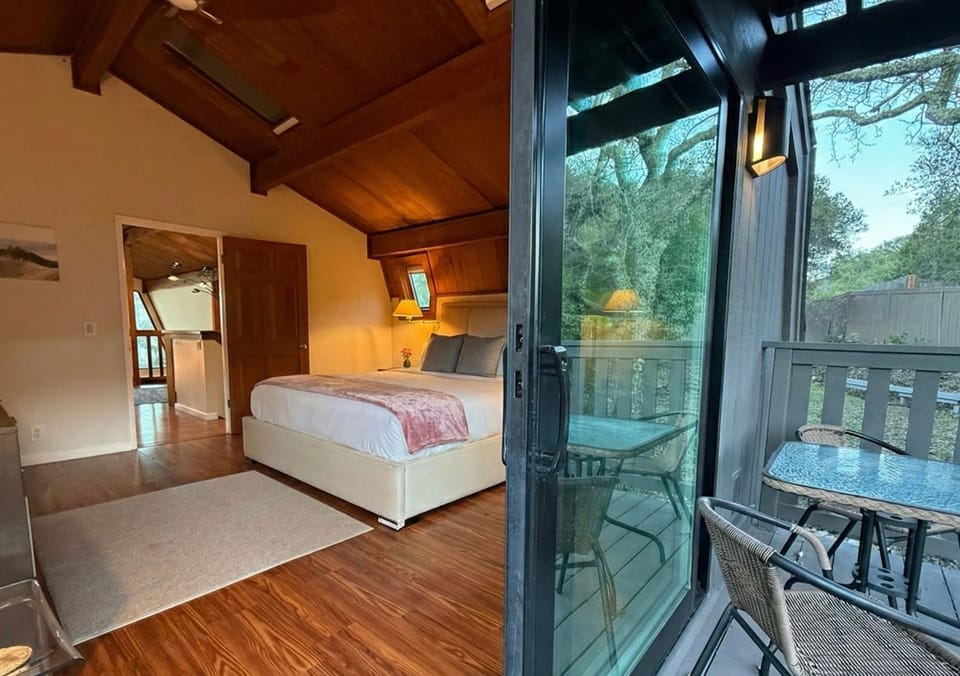 Master bedroom private deck — railing mountain view with table and chairs